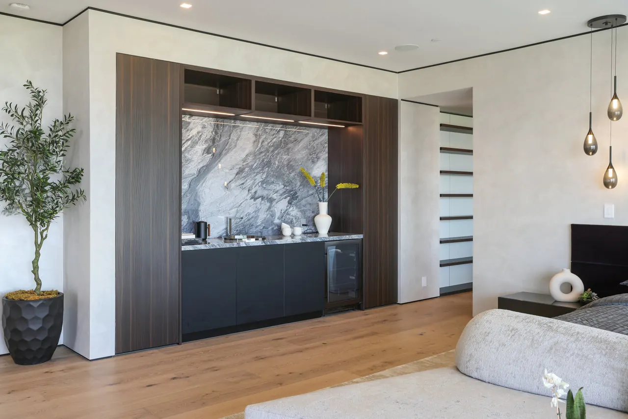Primary suite with a walnut and marble coffee bar at the Laurel View Residence, a Hollywood Hills home built by Valley Vista Builders